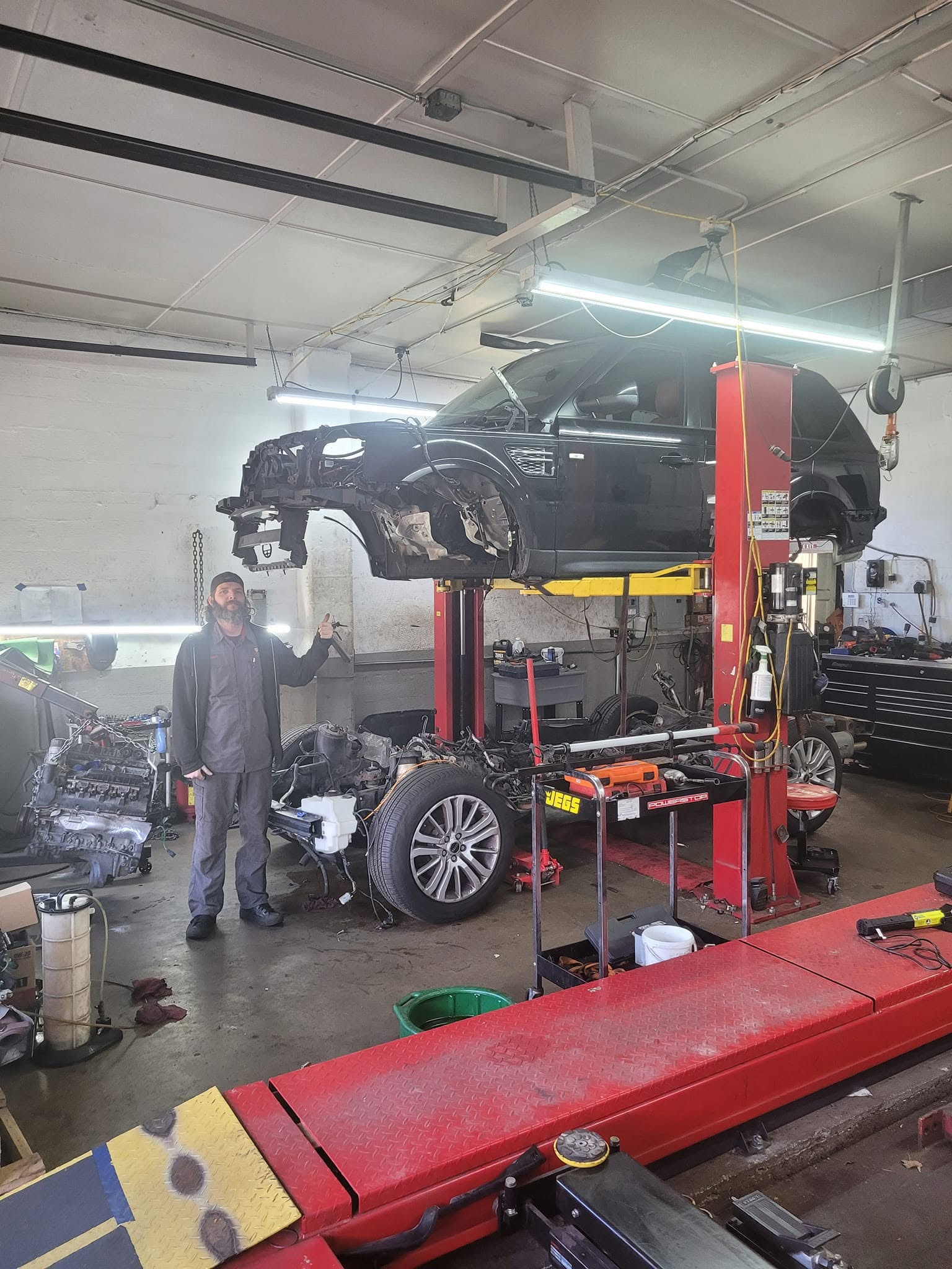 AutoDiagRX technician performing major vehicle repair in the shop